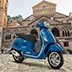 Modern scooter parked at a panoramic viewpoint overlooking the sea and the town of Amalfi